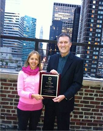 A person and person holding a plaque
AI-generated content may be incorrect.